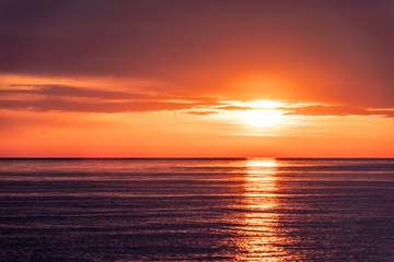 Naklejka na ściany i meble Beautiful red and orange sunset over the sea.