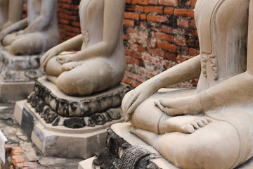 Rows of sacred buddha statues in lotus position at Wat Phra Si Sanphet in Ayutthaya, Thailand