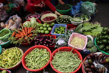 High angle view of a market vendor selling vegetables with no customers due to inflation and rising cost of food