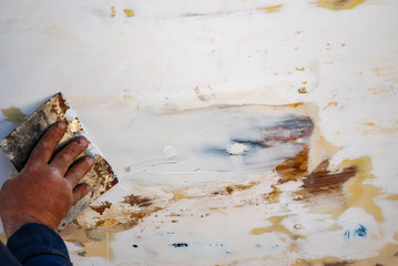 Man hand repairing or renovation wooden surface.