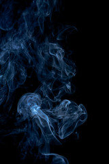 Blue smoke on dark background