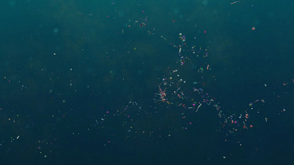 microplastics floating in the current, micro plastic pollution in ocean water