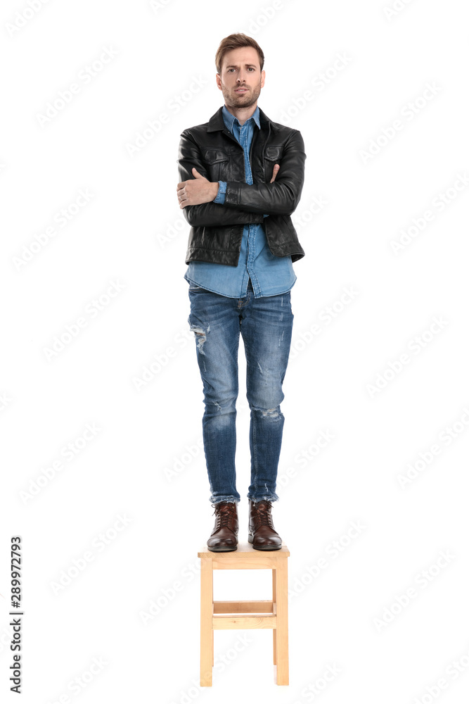 Canvas Prints man standing on chair with arms crossed