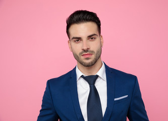 close up of handsome young man in navy blue on pink background