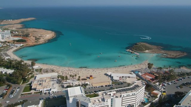Aerial footage ogf Ayia Napa coastline with sailing boats moving in circle in water