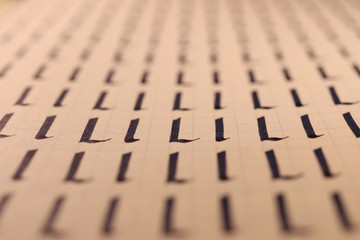 Lettering practice writing worksheet. Handwriting symbol filling pattern. Calligraphic letter L...