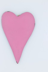 Wooden pink heart on a white background