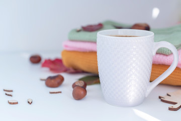 cosy autumn - cup of coffee, knitted sweaters and autumn leaves