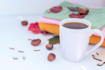 cosy autumn - cup of coffee, knitted sweaters and autumn leaves