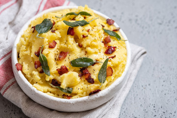 Mashed potatoes with crispy bacon and sage in a bowl