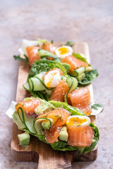 Lettuce wrapped smoked salmon tacos with fresh cucumber, avocado and quail eggs