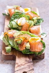Lettuce wrapped smoked salmon tacos with fresh cucumber, avocado and quail eggs