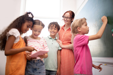 Cute children feeling entertained during math class