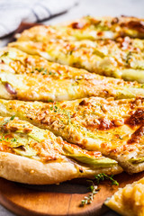 Vegetarian pizza with zucchini, cheese and nuts. Healthy food concept.