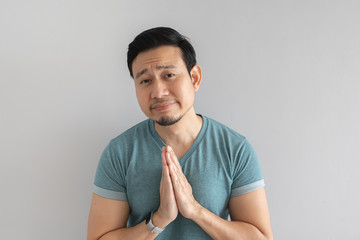 Man is begging for something on grey background.