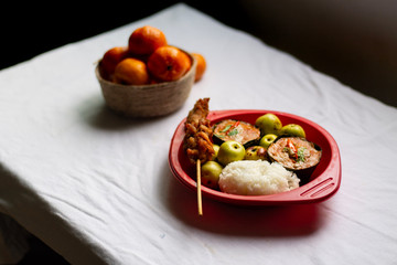 Traditional Thai meal of Haw Moak or steamed curried fish with white steamed rice and clementine oranges