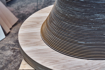 Fototapeta na wymiar Joinery. Creative round shape coffee table made of mdf and natural wood