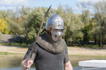 A guy in knightly armor is photographed on the banks of the Sozh River. Celebration on the...