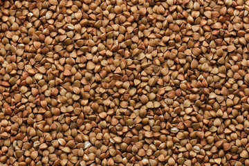 raw buckwheat  close up as background. Grain groat texture.