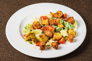 caesar salad on the white plate
