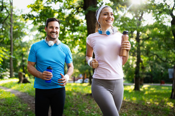 Happy couple running and exercising together outdoor