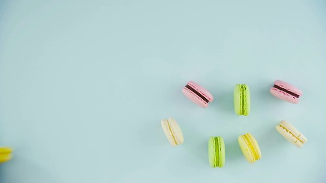 Macaroons or macaron on pastel blue surface. Close up.