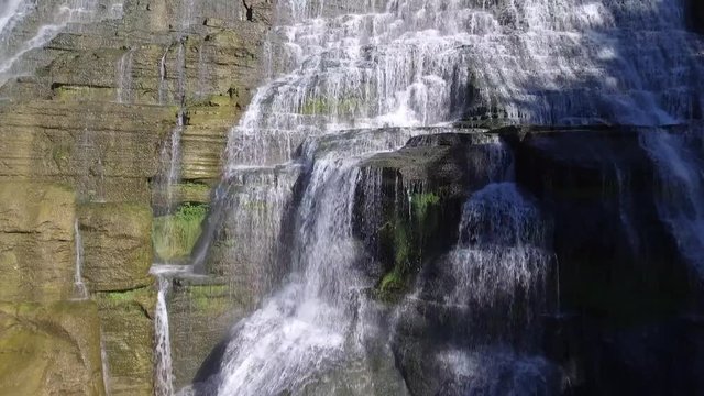Ithaca Falls large waterfall cascade in Upstate, New York, aerial shot closeup to wide view
