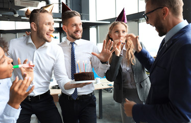 Business team celebrating a birthday of collegue in the modern office