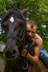 Fototapeta premium man with a naked torso riding horse