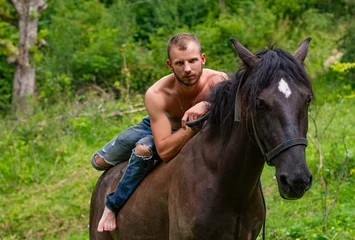 Foto op Canvas male rider relaxed on horseback © kavardakova