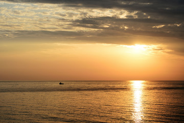 Naklejka na ściany i meble Beautiful sunrise over the sea on the coast of Sicily. Cefalu, Italy