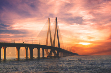 Bandra Worli sea link bridge of Mumbai and golden dramatic sky and cloud - obrazy, fototapety, plakaty