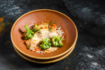 Fresh baked sea fish with broccoli, carrots, vegetables and cheese. Superfood. Vegitarian Menu