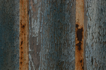 An old blue background of blue color with iron rusty bars that has stood for many years.