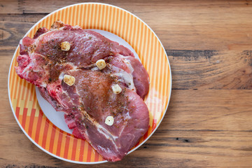 raw meat with herbs and garlic for grill on dish