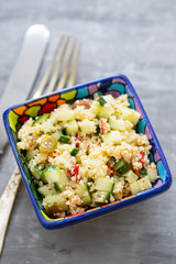 tabbouleh in small bowl on ceramic background