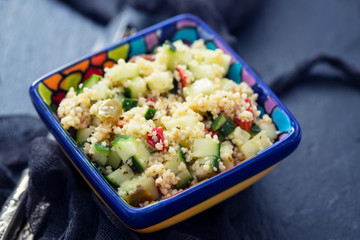 tabbouleh in small bowl on ceramic background