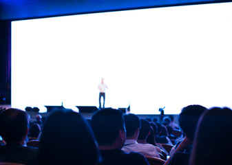 Business presentation being given by executive manager. Corporate seminar with expert speaker presenting to people. Presenter giving speech during lecture. Leadership training coach in workshop.