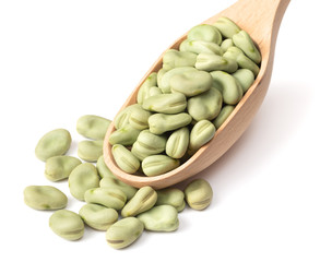 dried green broad beans in the wooden spoon, isolated on white background