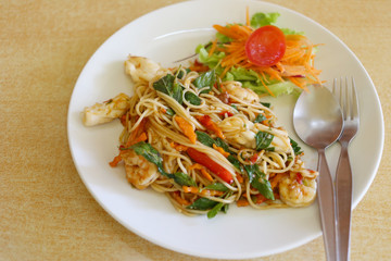 Spicy Stir Fried Spaghetti with Seafood in a white dish.
