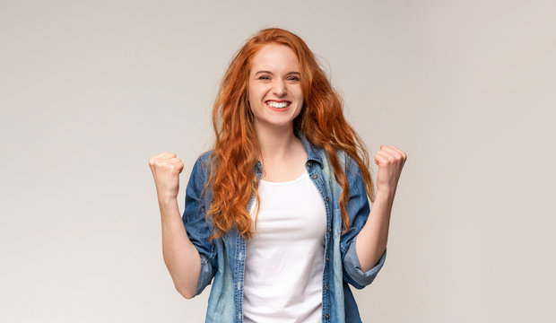 Redhead Teen Girl Shaking Fists Celebrating Victory