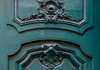 Details of gorgeous antique wooden door with curved frames and baroque style volute decorations....