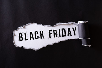 Top view of Black torn paper and the text black friday on a white background. Black Friday...