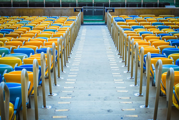 Naklejka premium Soccer stadium hall with yellow and blue seats