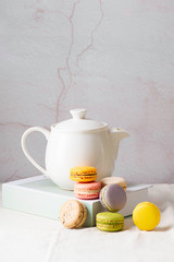 Hot tea and macaron on the table vintage style .Macaron cookies. Homemade macaron cookies for dessert