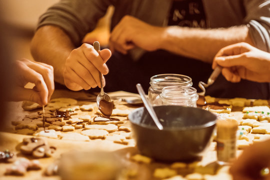 Group of young people baking cookies for christmas