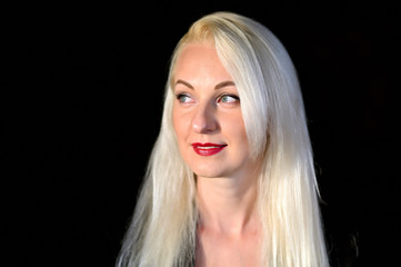 Naklejka premium Creative concept large portrait of a pretty blonde girl with long beautiful hair on a colorful background in the studio. Cosmetics, facial skin, art.
