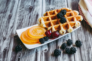 Petit déjeuner sain avec lait gaufre mûres du jardin et fruits confits