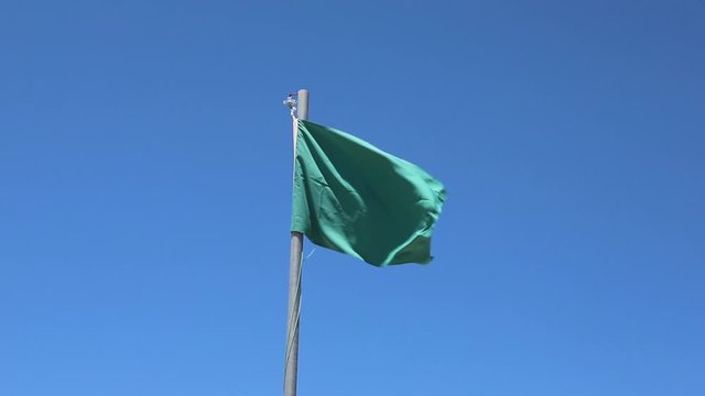 green flag with blue sky