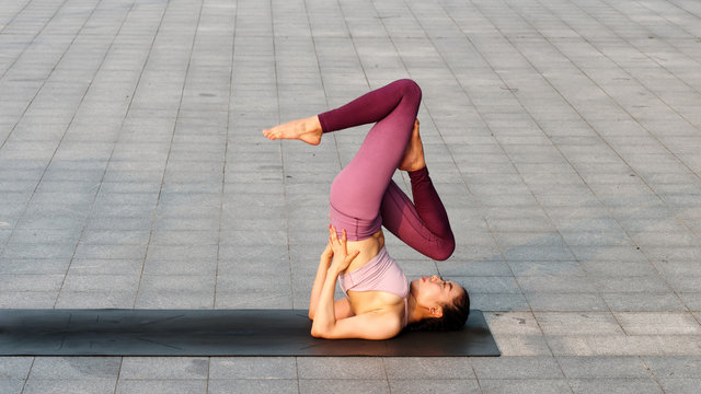 Slim woman doing Salamba Sarvangasana pose on yoga mat - a Royalty Free  Stock Photo from Photocase